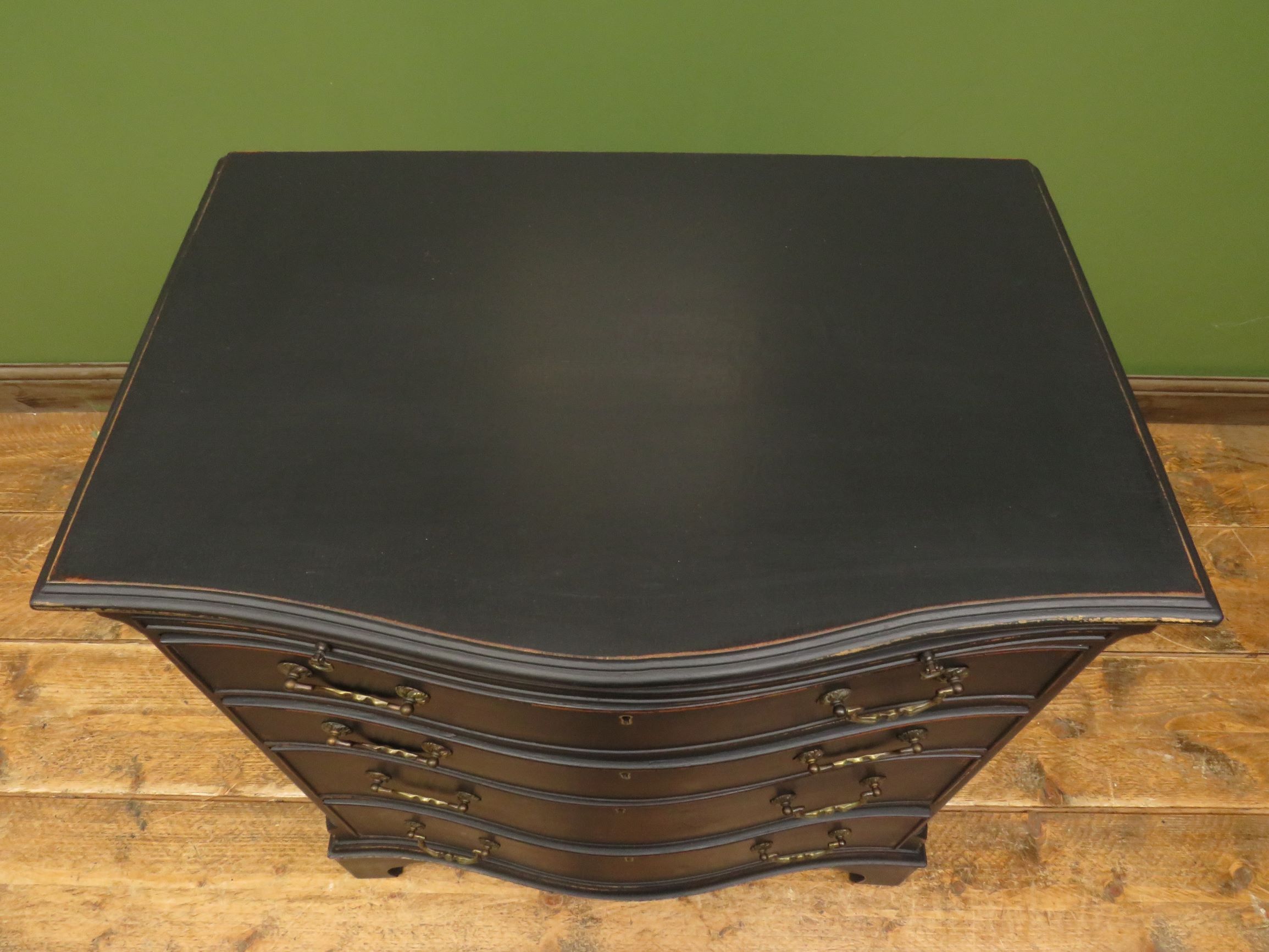Antique black painted serpentine bachelors chest of drawers