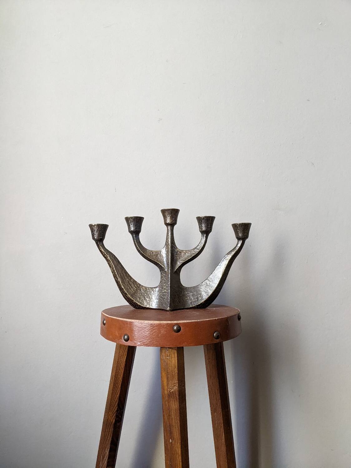 Vintage bronze candlestick chandelier in contemporary Scandinavian design.