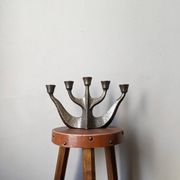 Vintage bronze candlestick chandelier in contemporary Scandinavian design.