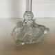 Thick moulded glass candlestick with fish and flowers.
