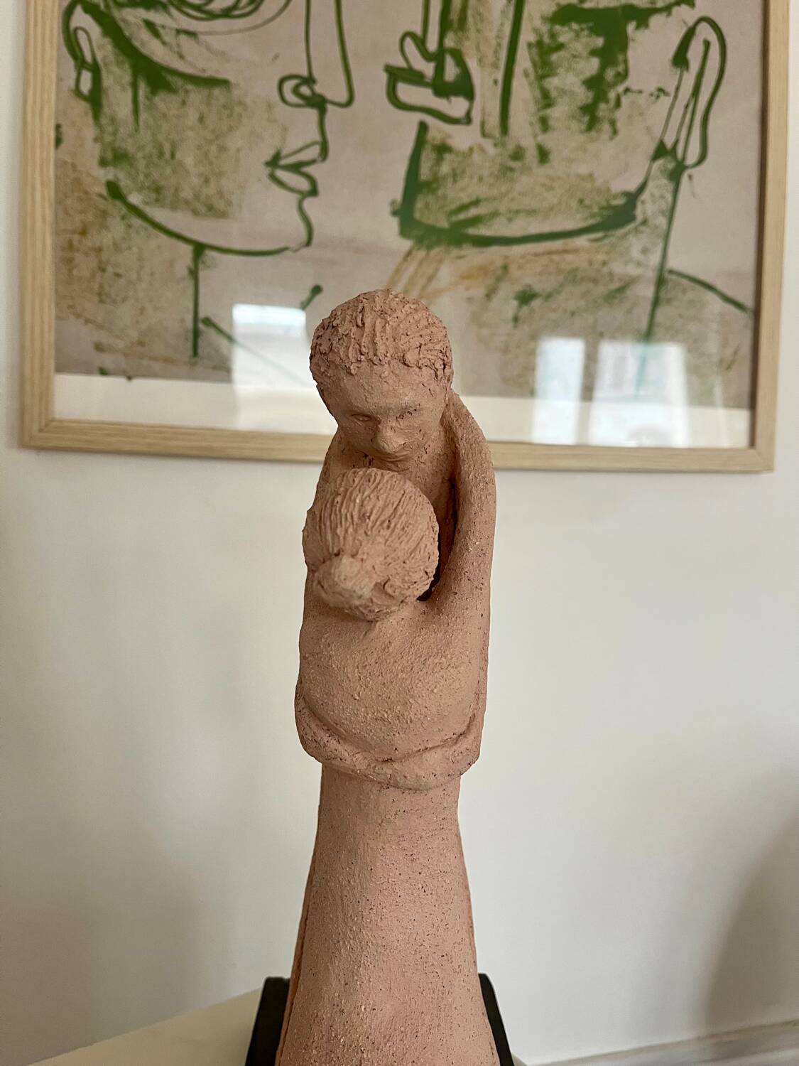 Sculpture of a couple entwined in grog clay.