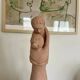 Sculpture of a couple entwined in grog clay.