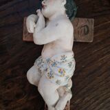 Child on the polychrome plaster cross