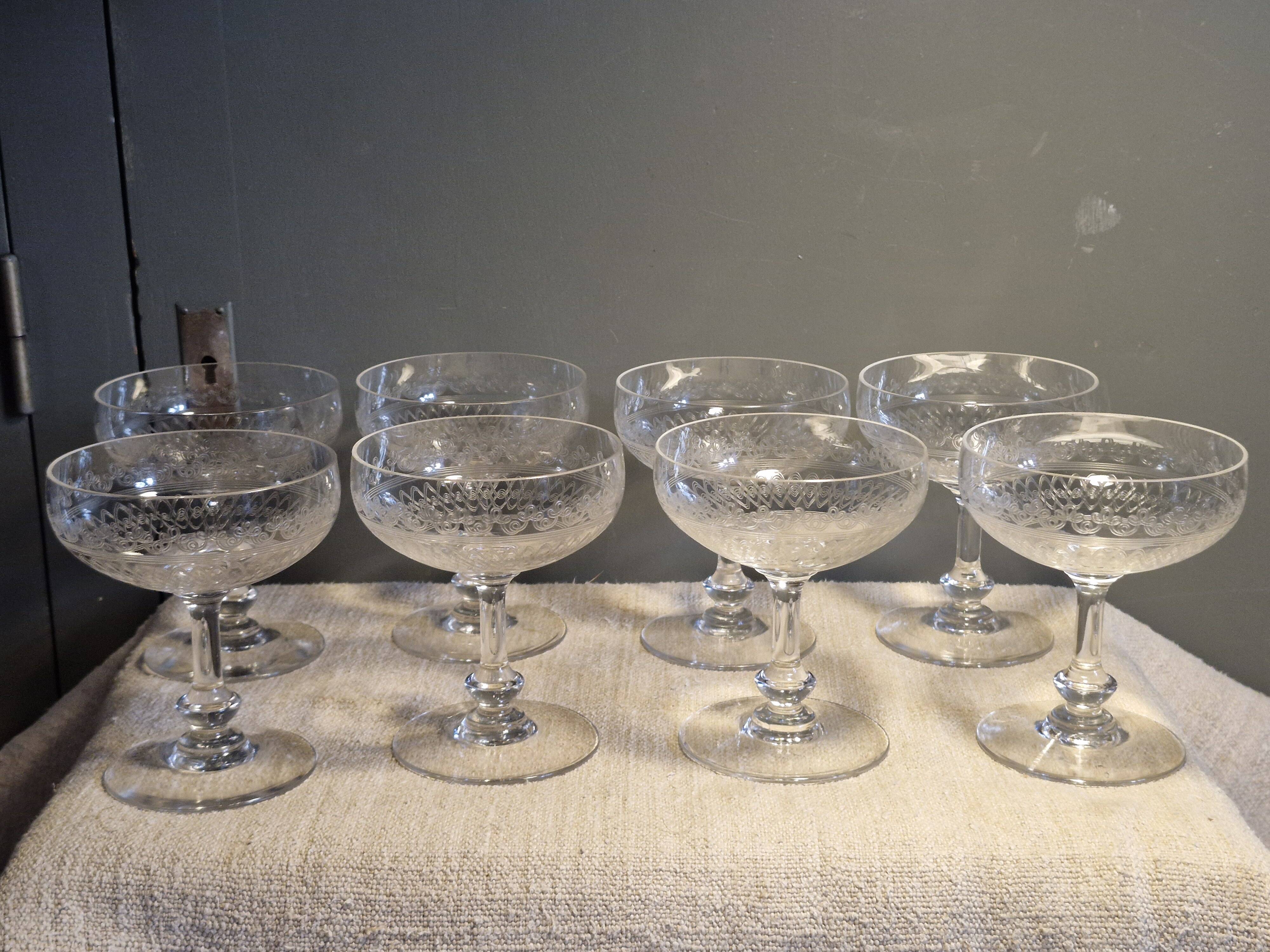 8 antique Baccarat crystal champagne coupes with engraved decoration.