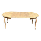 Large round/oval dining table in a chic country style, made of stripped oak with an extension.