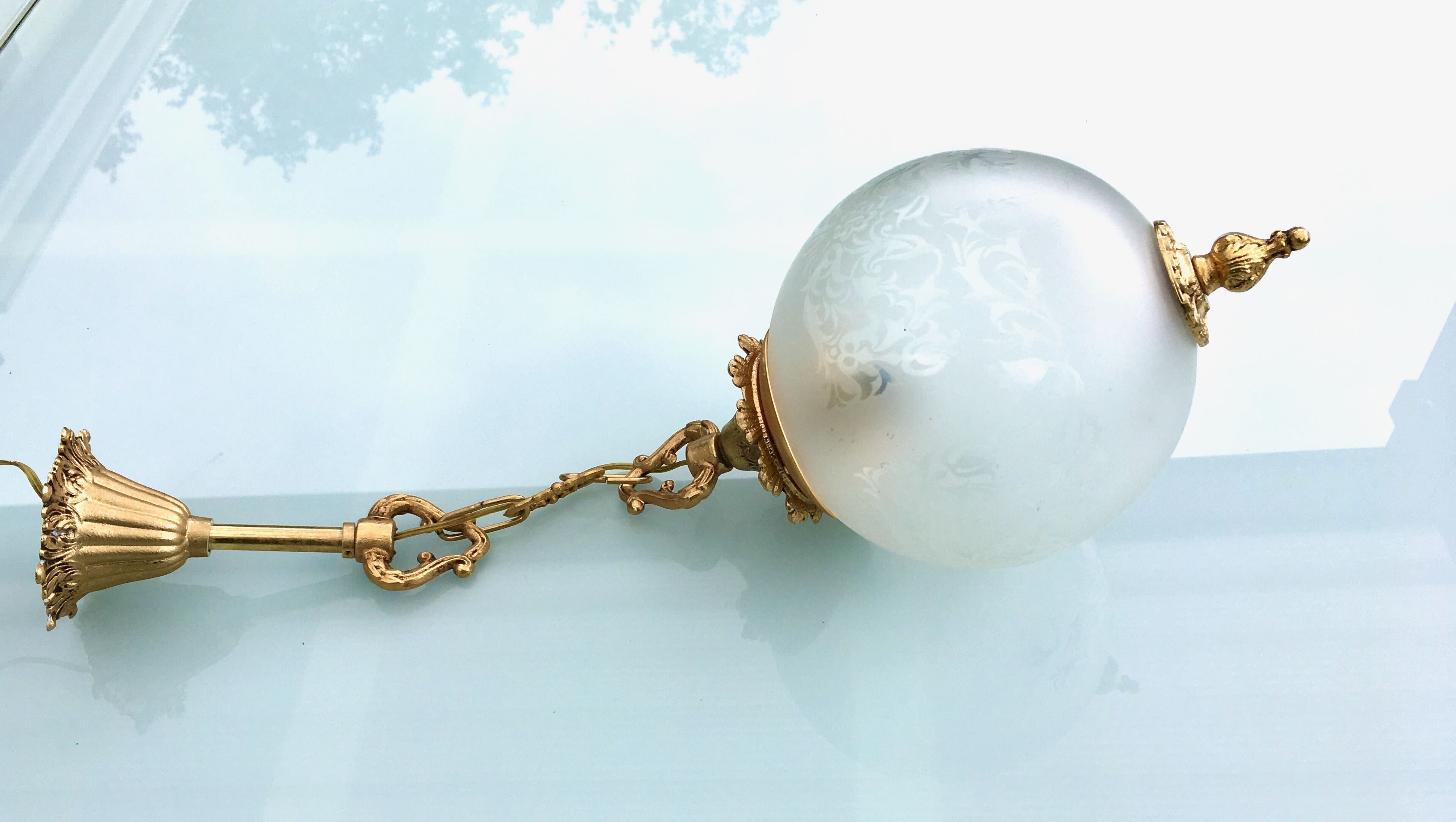 Floral globe and gold metal hanging lamp