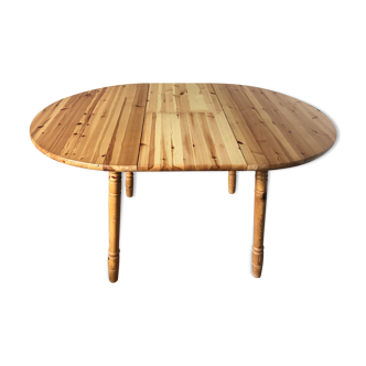 Round table in varnished pine with extension cord