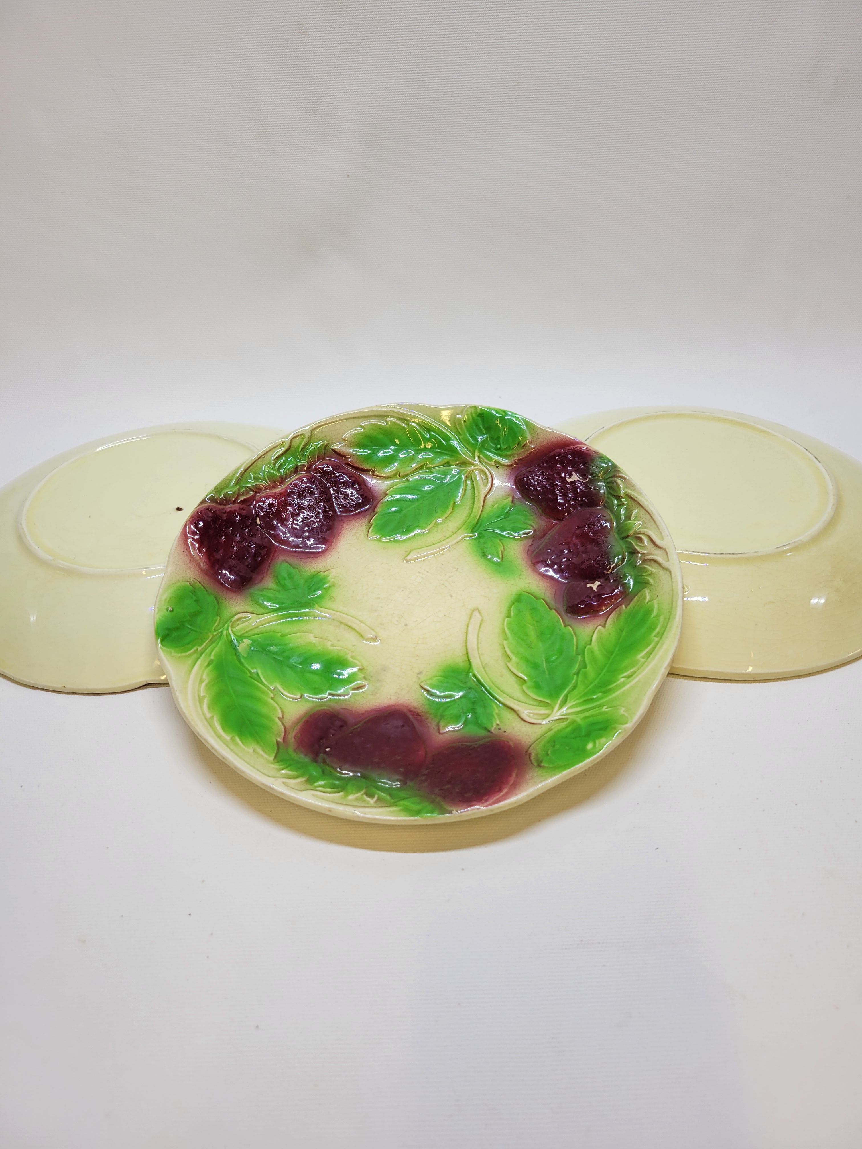 3 old plates in slip decoration strawberries and grapes