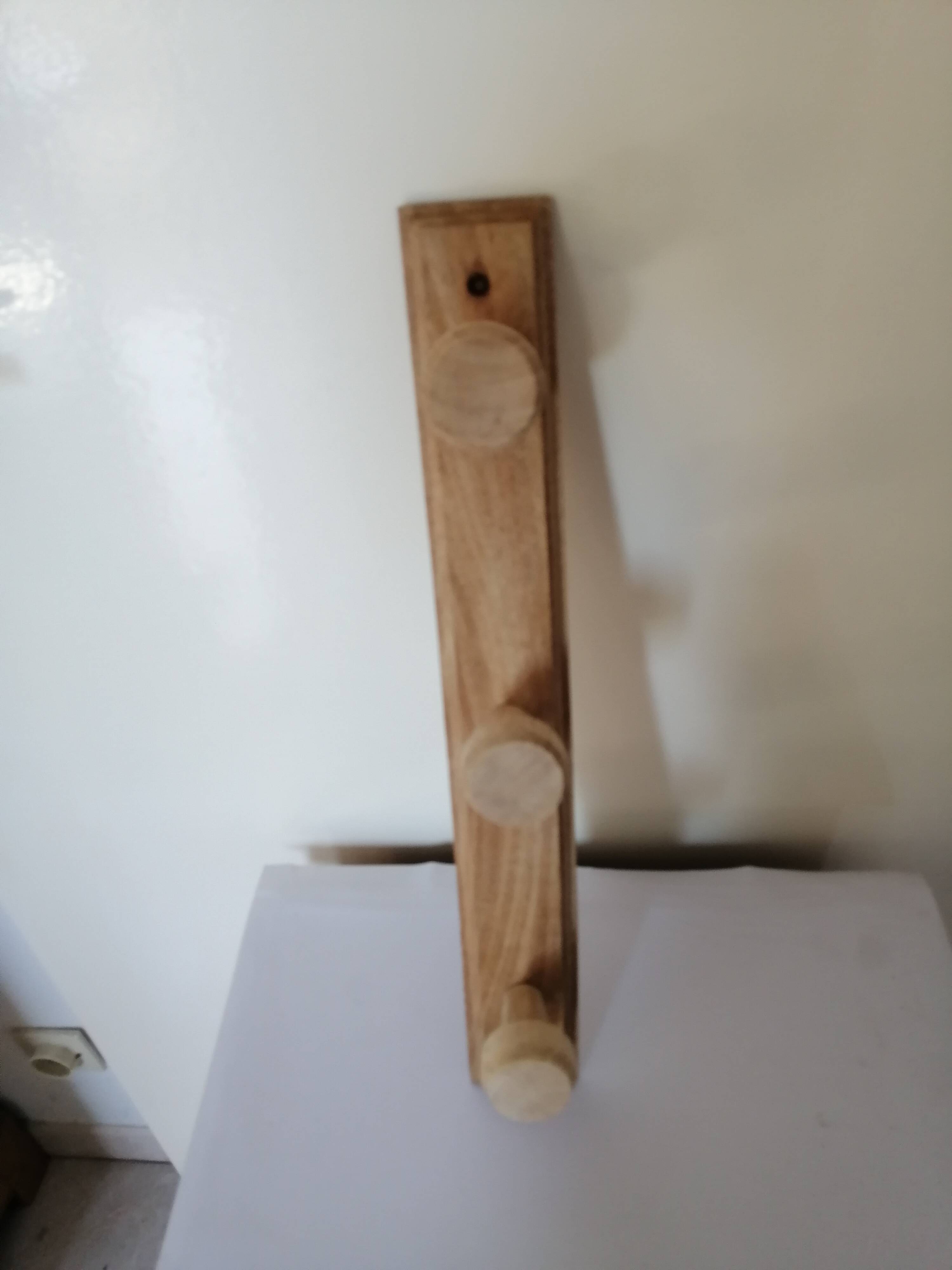 Old wall coat rack in raw wood