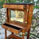 A small piece of Bonheur du jour with detached columns in Empire-era mahogany.