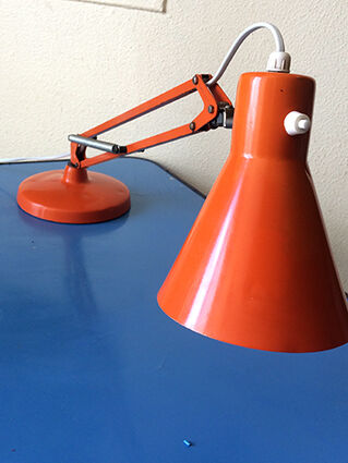 Luxo L9 orange single-arm lamp on plinth