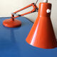 Luxo L9 orange single-arm lamp on plinth