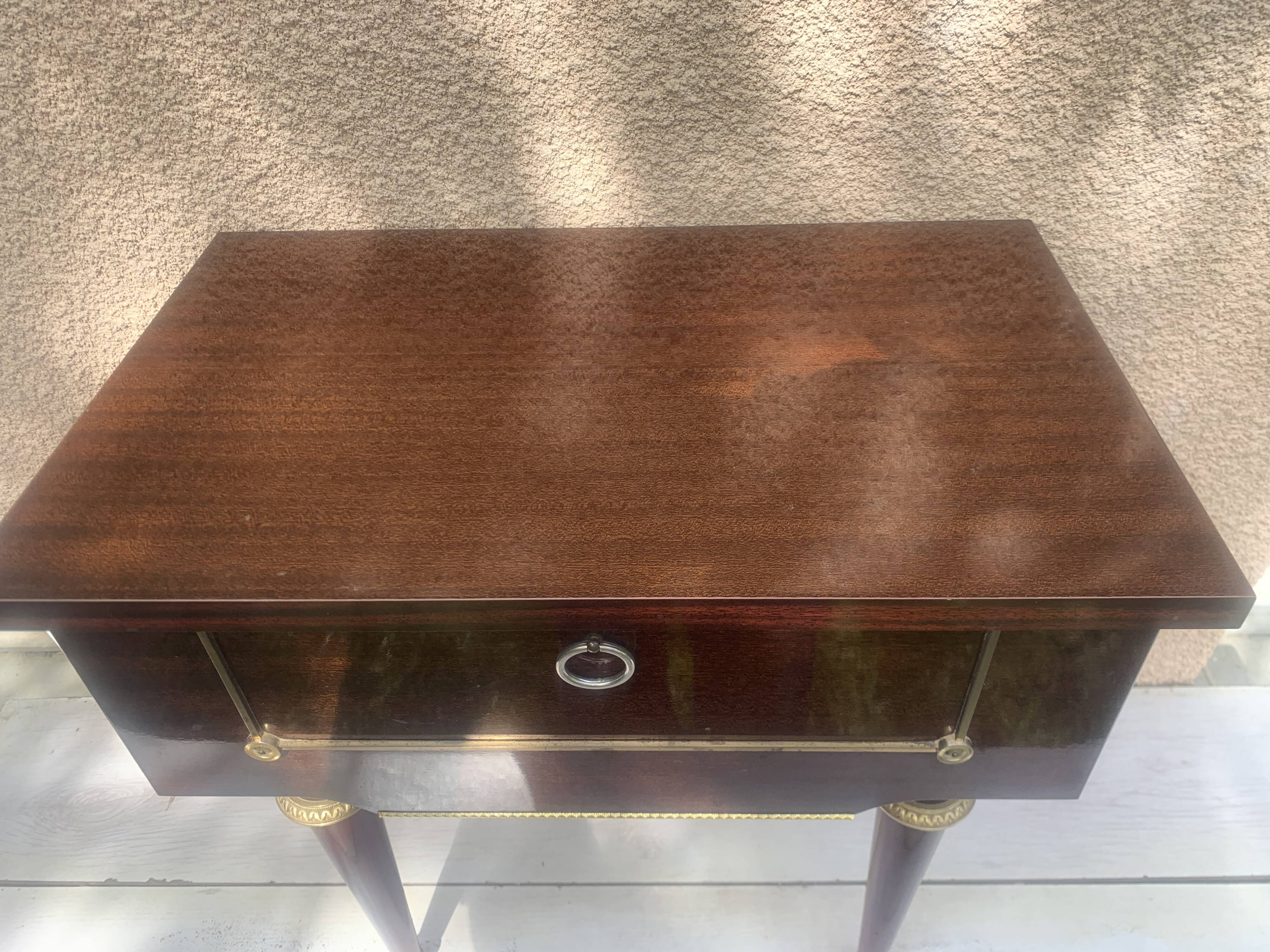 Nightstand with lovely mid-century style gold metal decor.