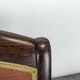 Restoration armchair in mahogany with cross arms and orange fabric.