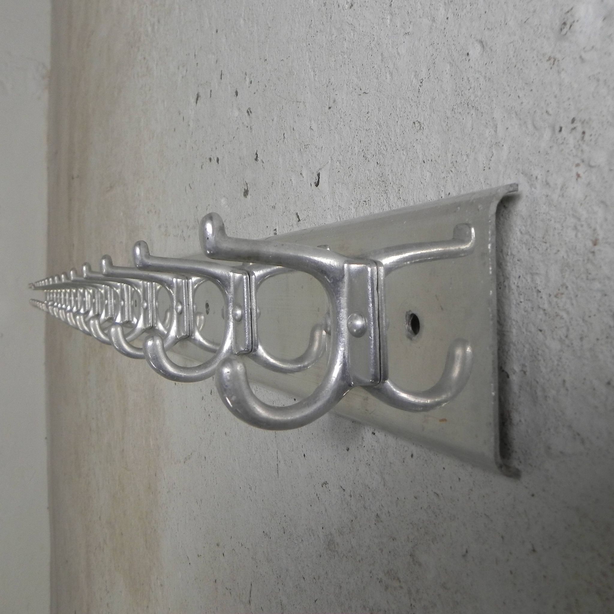 Wall-mounted aluminium coat rack of 225 cm with 16 double hooks, 1960s.