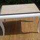 Oak coffee table with curved legs.