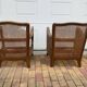 Pair of 1920s brown armchairs in carved wood and fabric, with caning detail.