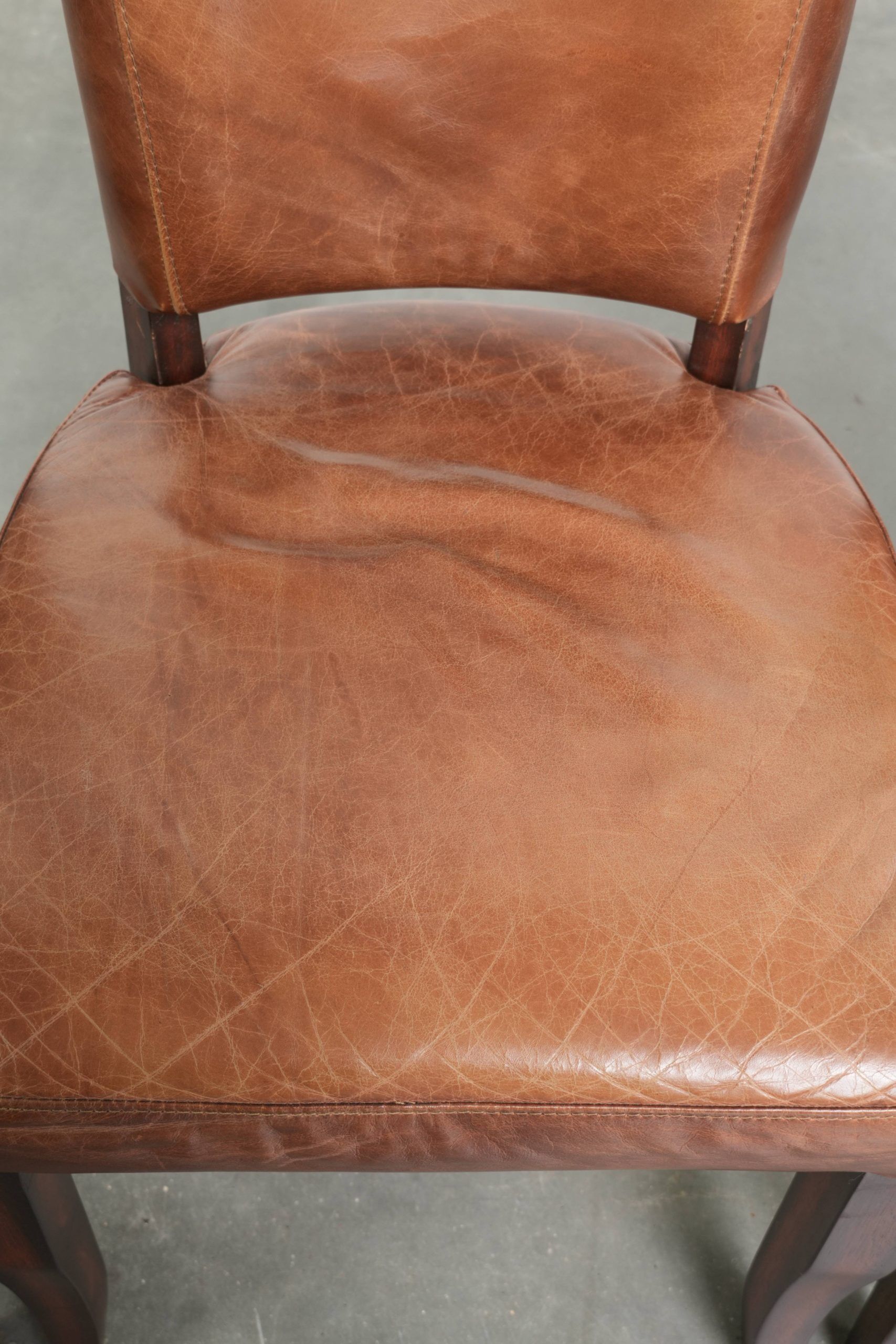 Set of 4 cognac-coloured cowleather dining chairs with decorative nails