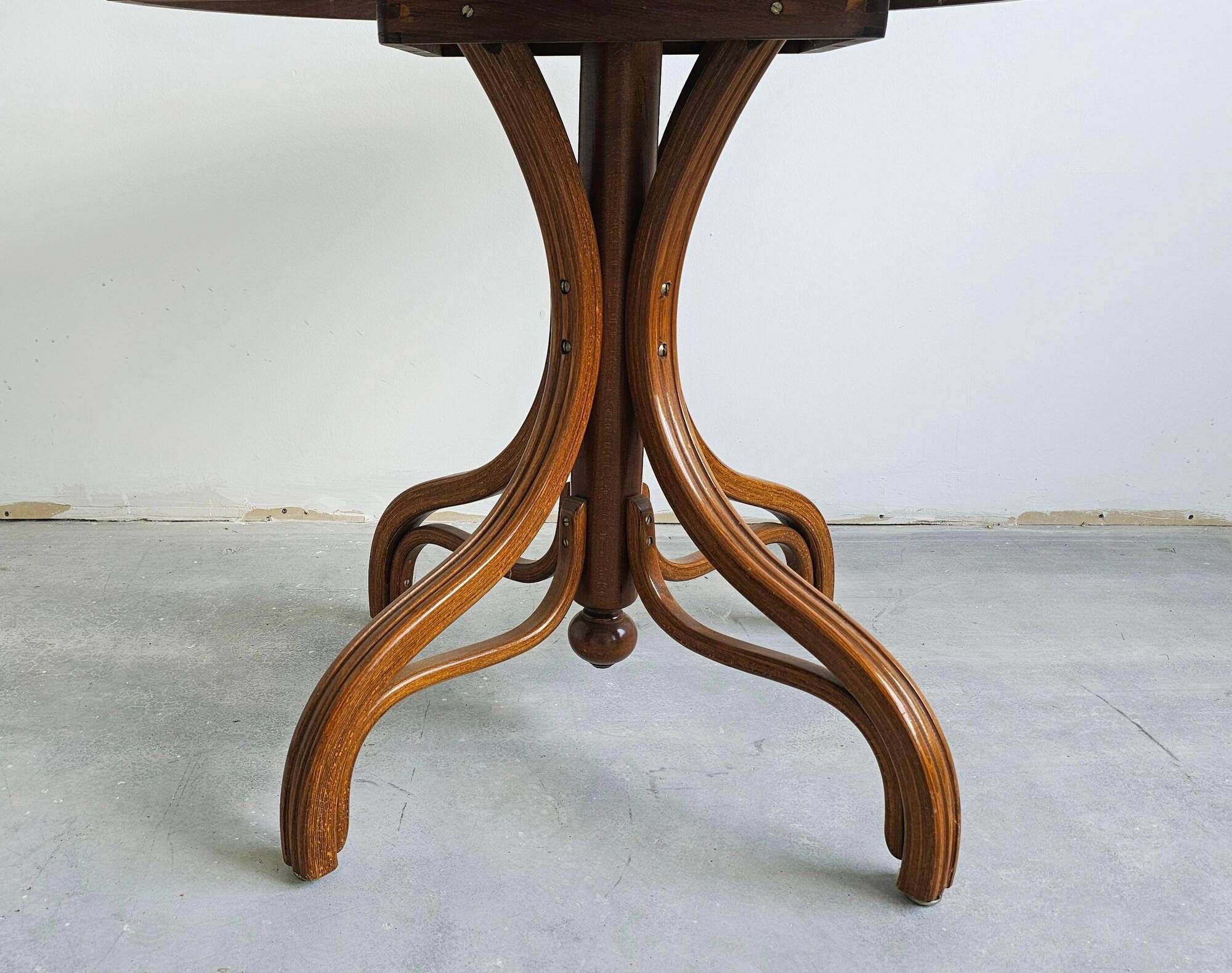 Round dining table in curved wood with a rattan top by Mundus, 1960s.