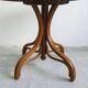 Round dining table in curved wood with a rattan top by Mundus, 1960s.