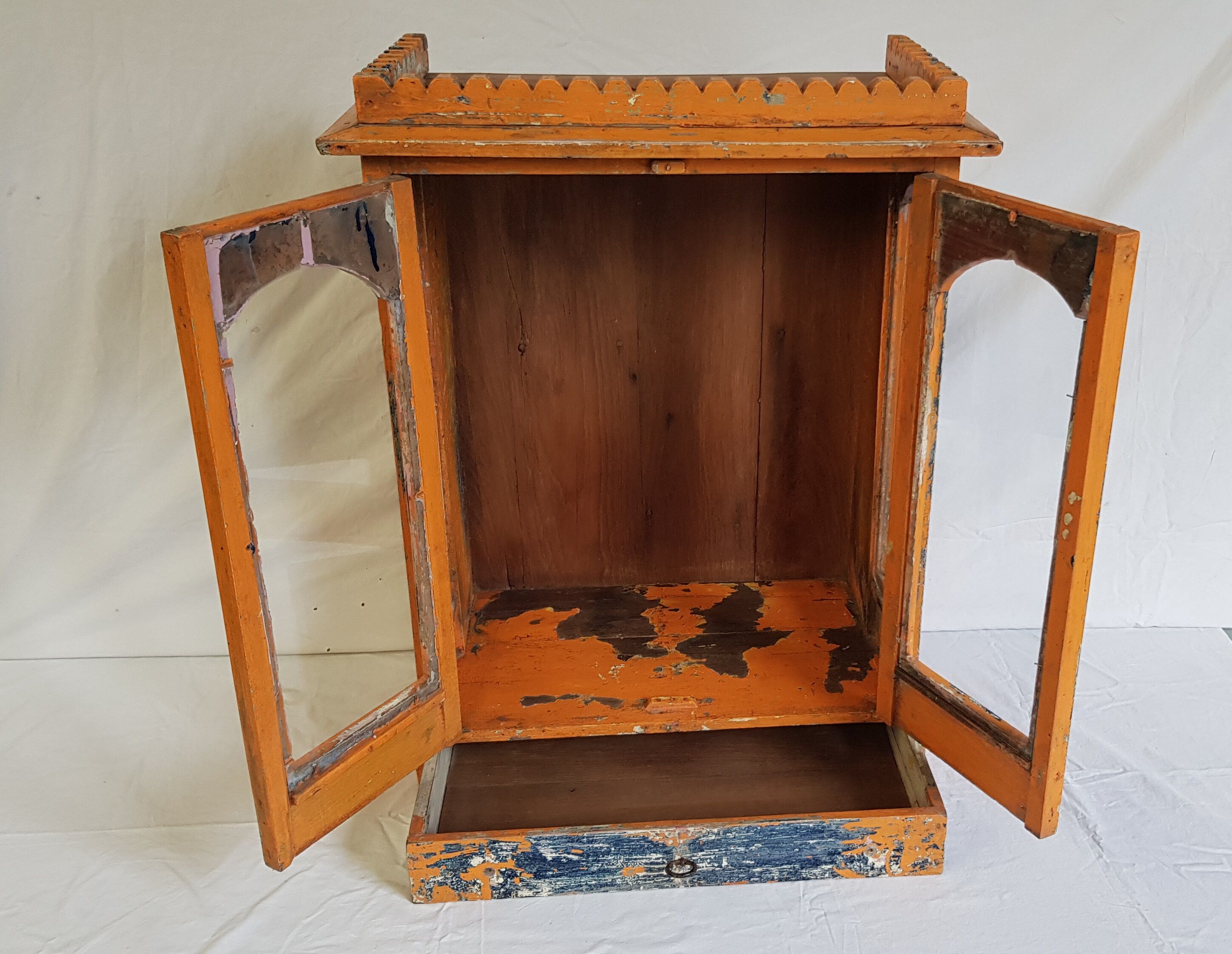 Old temple-showcase with teak offerings
