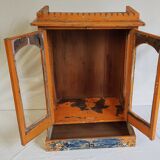 Old temple-showcase with teak offerings