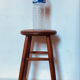 Vintage four-legged stool made of solid wood from the 1970s/80s.