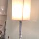 Silver floor lamp with a straight shade.