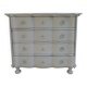 A beautifully crafted crossbow-shaped chest of drawers, finished in pearl grey with a whitewashed top.