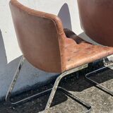 Pair of leather chairs by Robert Haussman