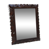 Old beveled mirror with carved wooden frame