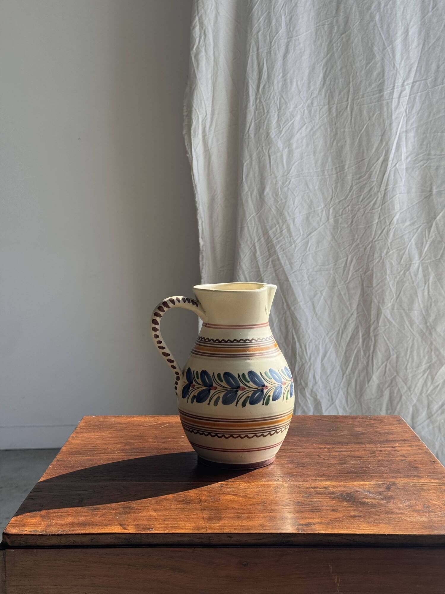 Beige carafe with stylized blue flower friezes