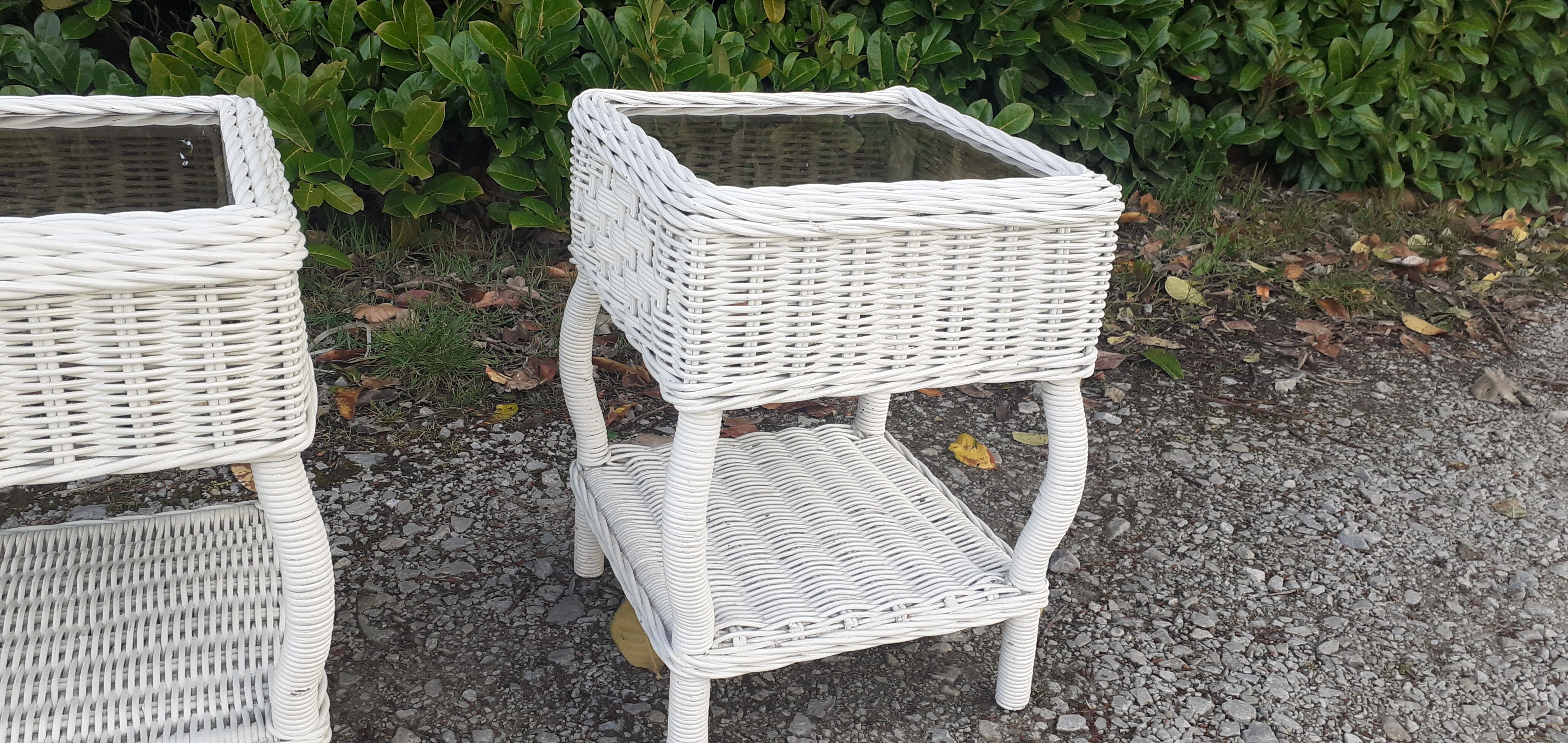 Pairs of white rattan side tables and smoked glass