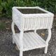 Pairs of white rattan side tables and smoked glass
