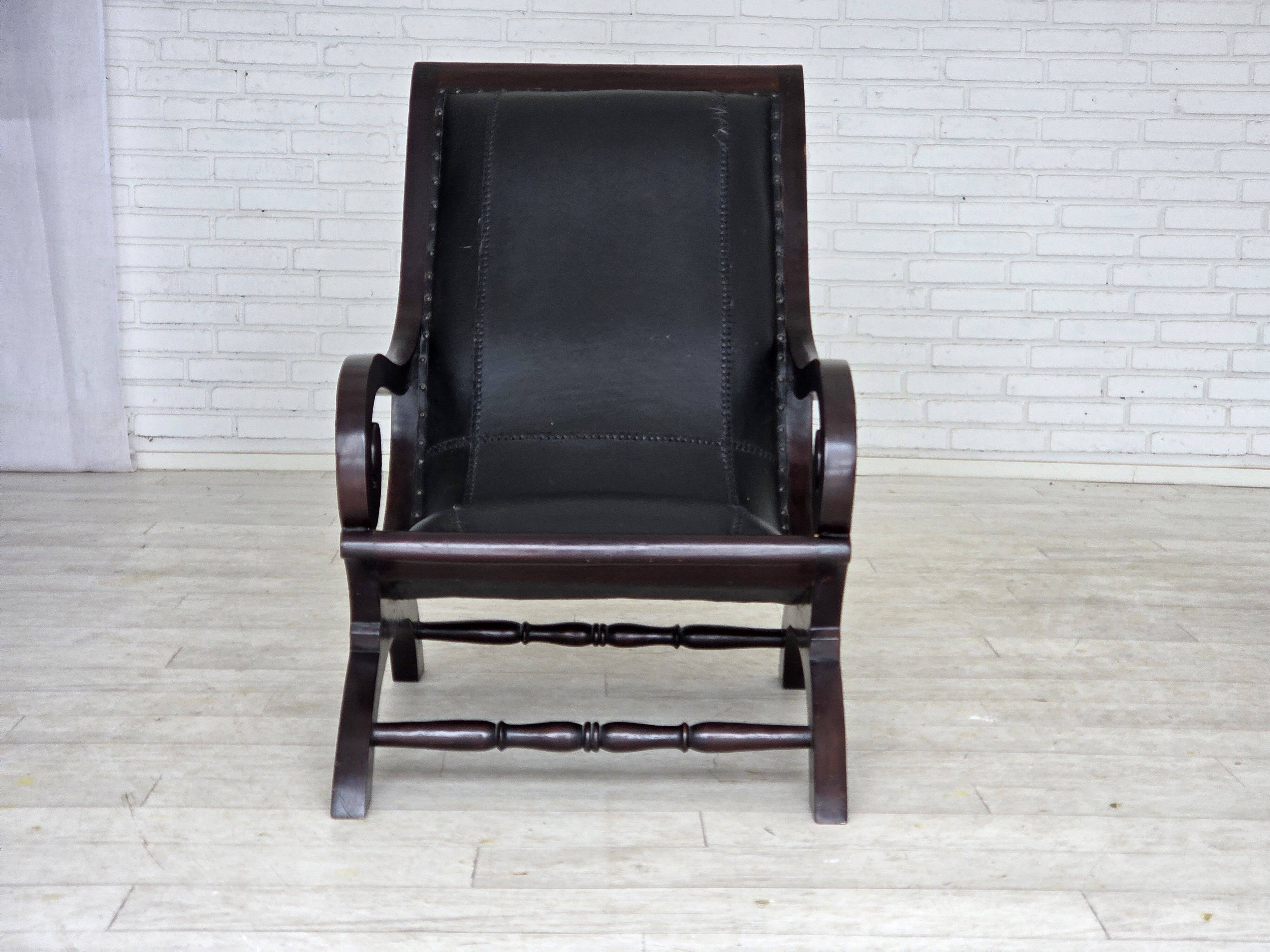 1970s, vintage armchair with footstool, black furniture leather.