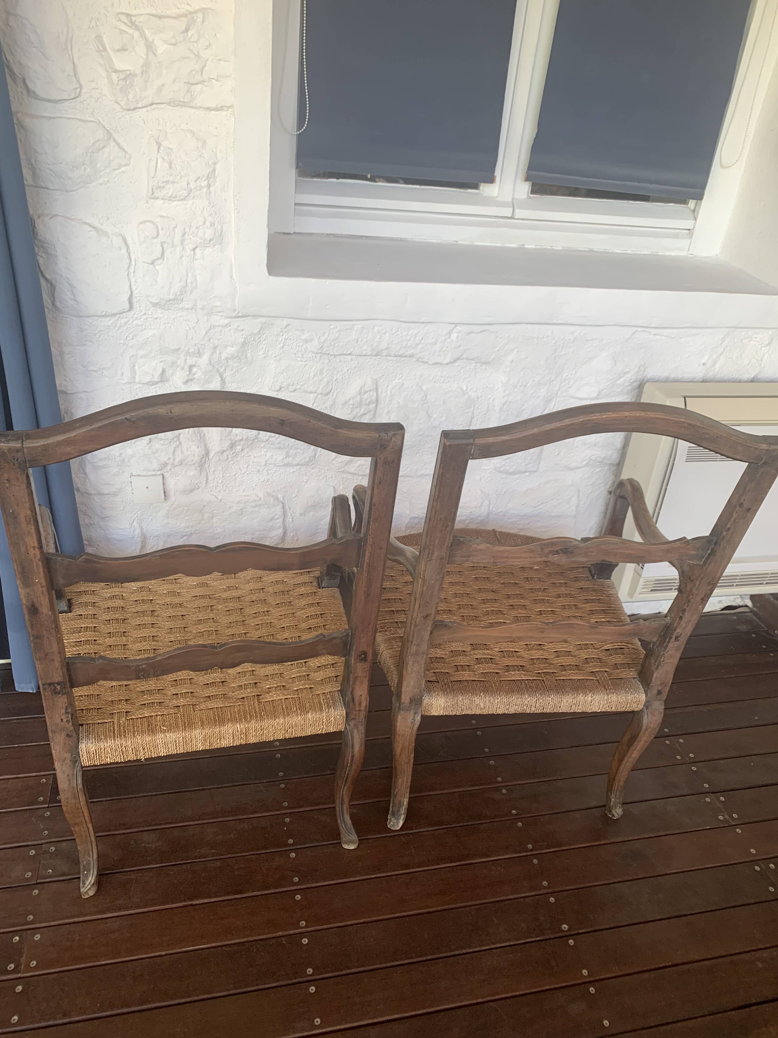 Pair of antique wooden armchairs with woven seats + cushions