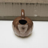 Old pitcher in glazed brown ceramic