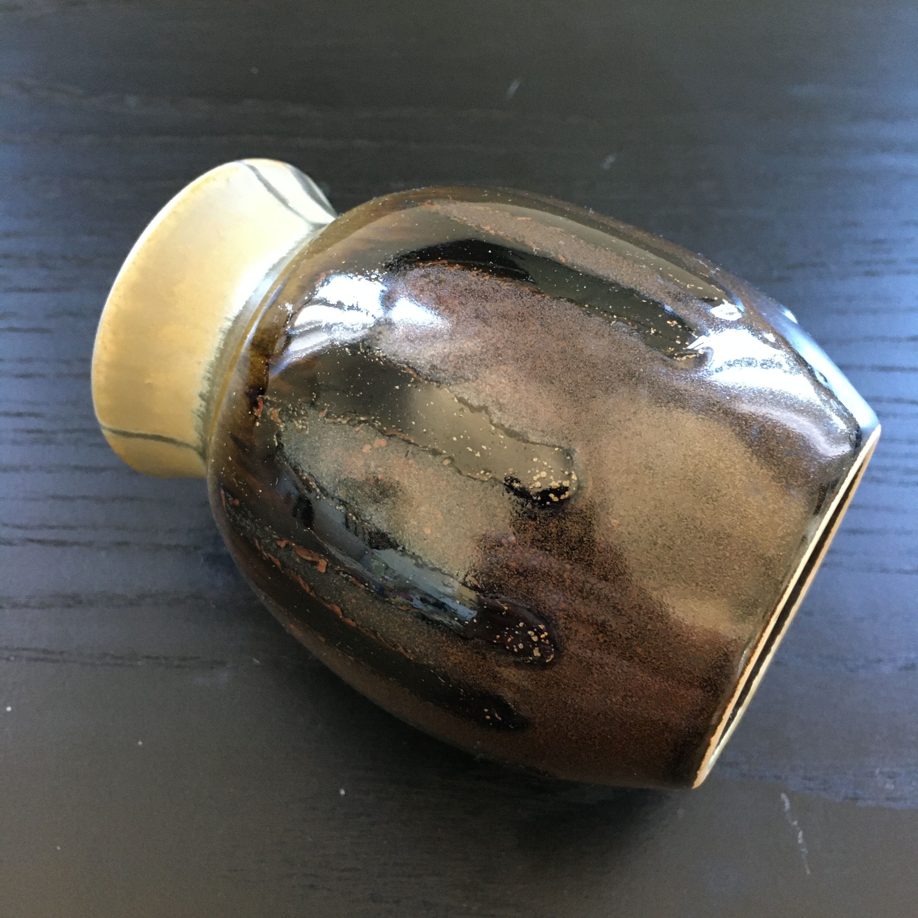 Brown and black flame-colored vase
