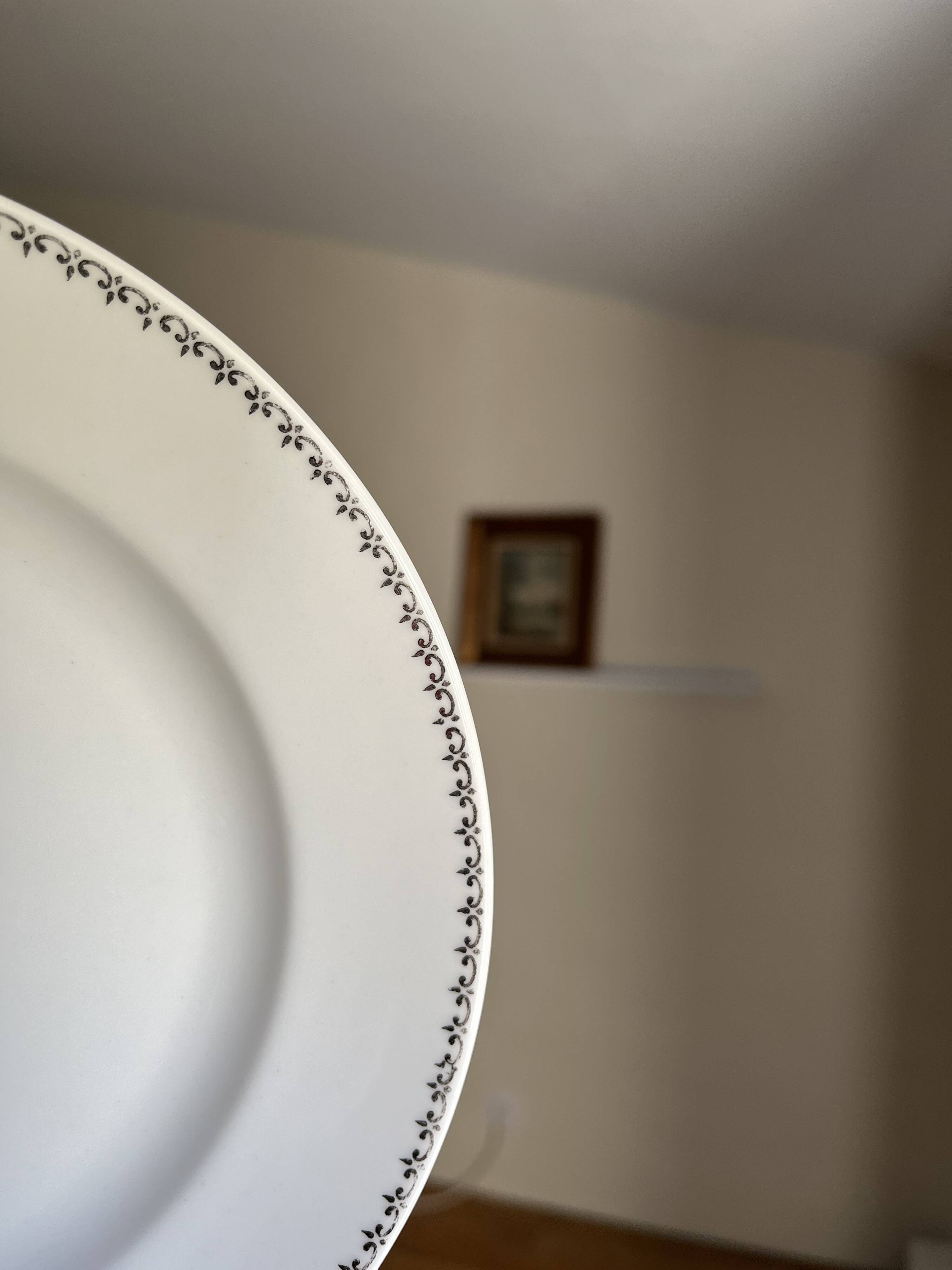 12 white porcelain plates with silver edging