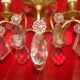 Pair of bronze and crystal wall lights with three candle holders from the early 20th century.
