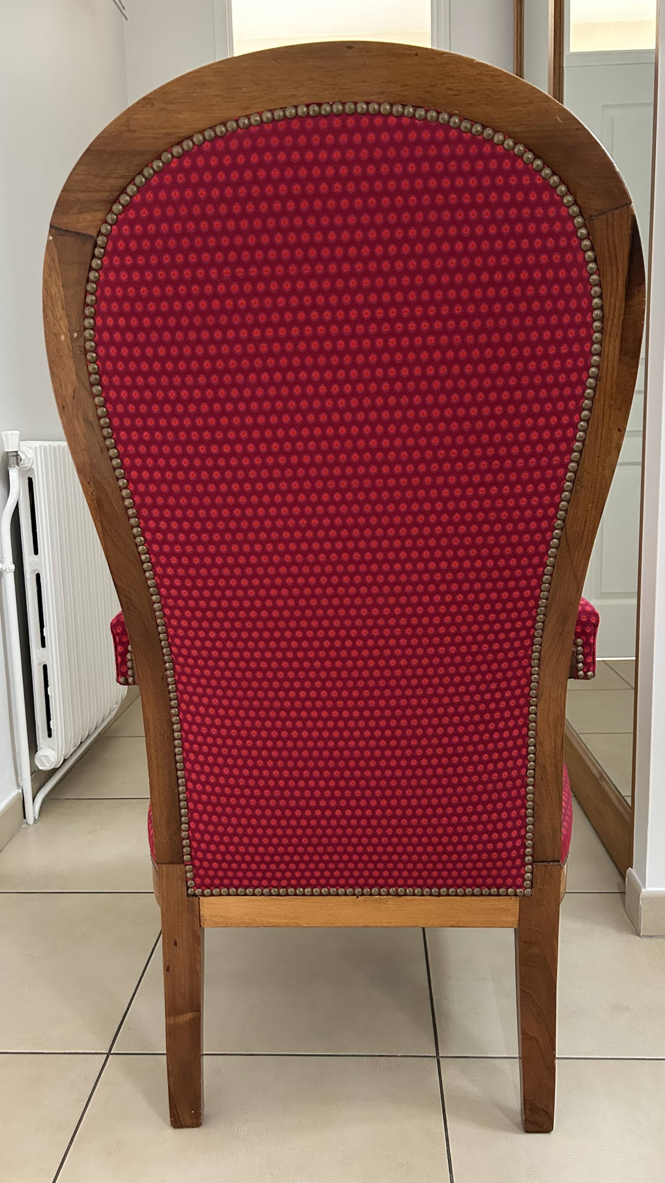Antique Louis Philippe armchair in walnut and red fabric.