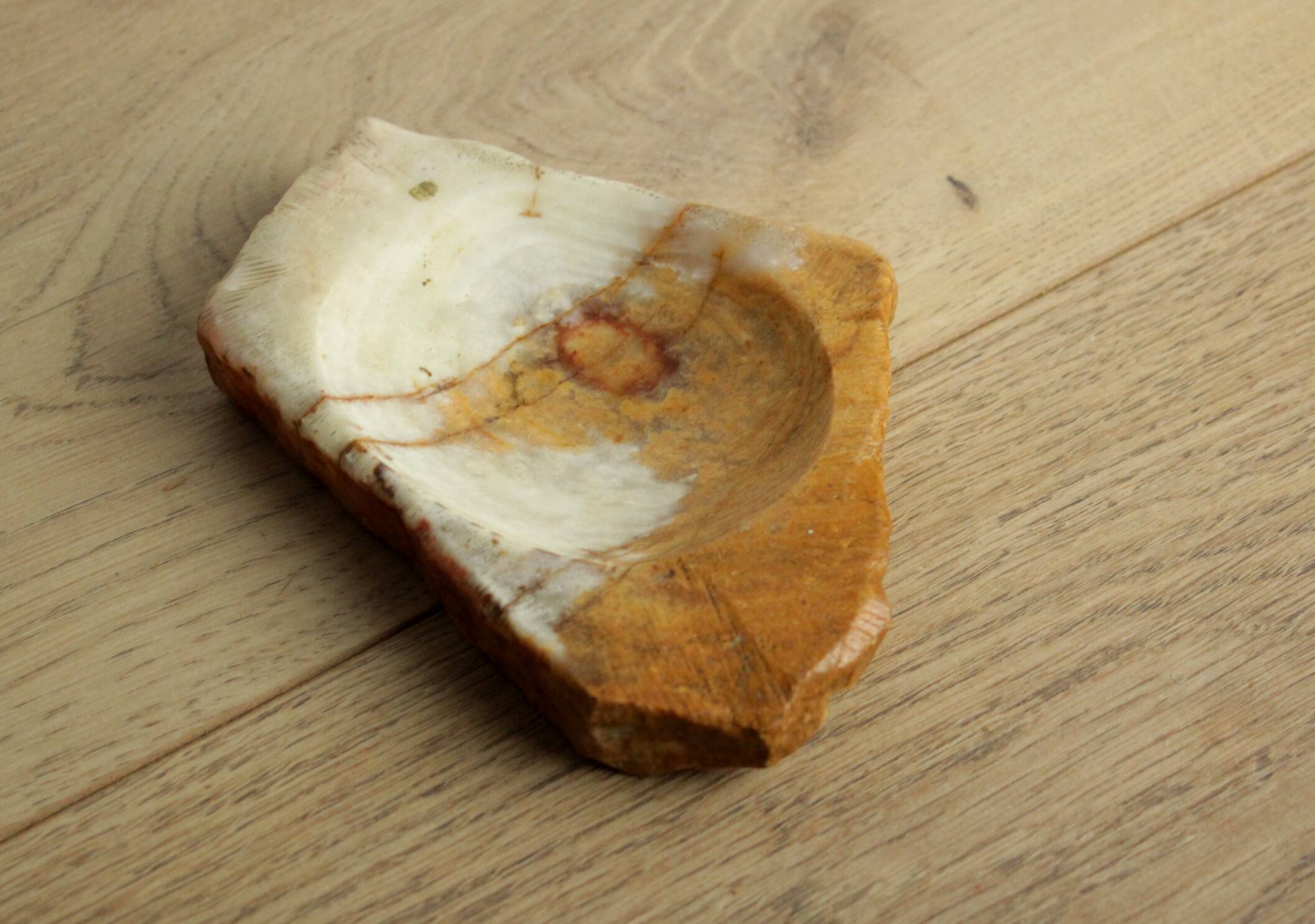 Empty pocket in orange and white marble ashtray
