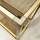 Golden metal shelf and smoked glass