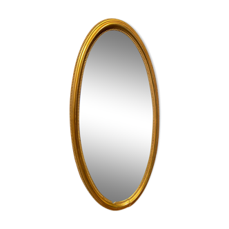 Oval mirror in a frame