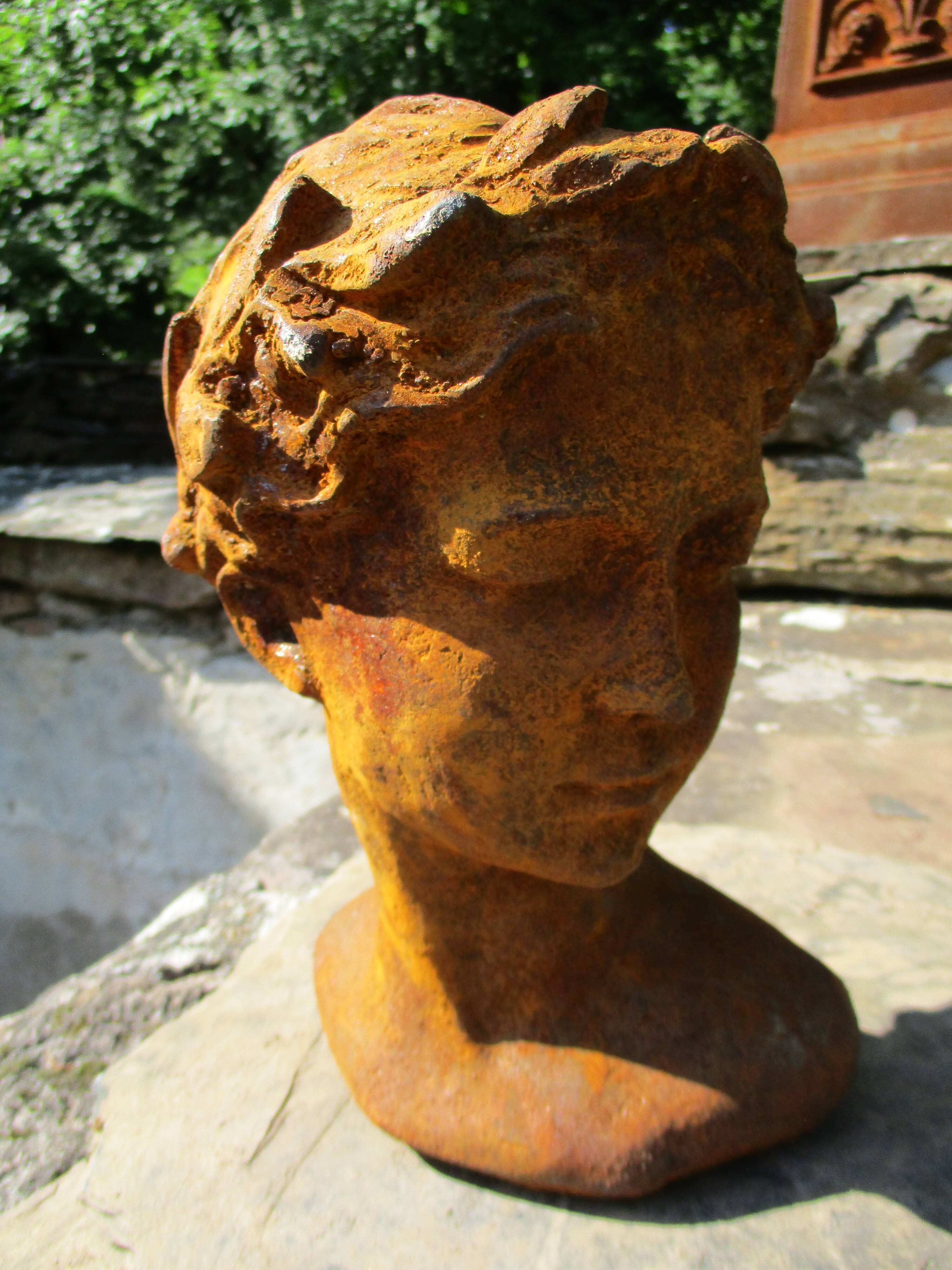 Cast iron sculpture of a woman.