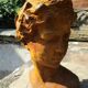 Cast iron sculpture of a woman.