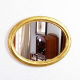 Golden oval mirror with leaf