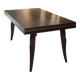 Solid oak dining table with integrated extensions.