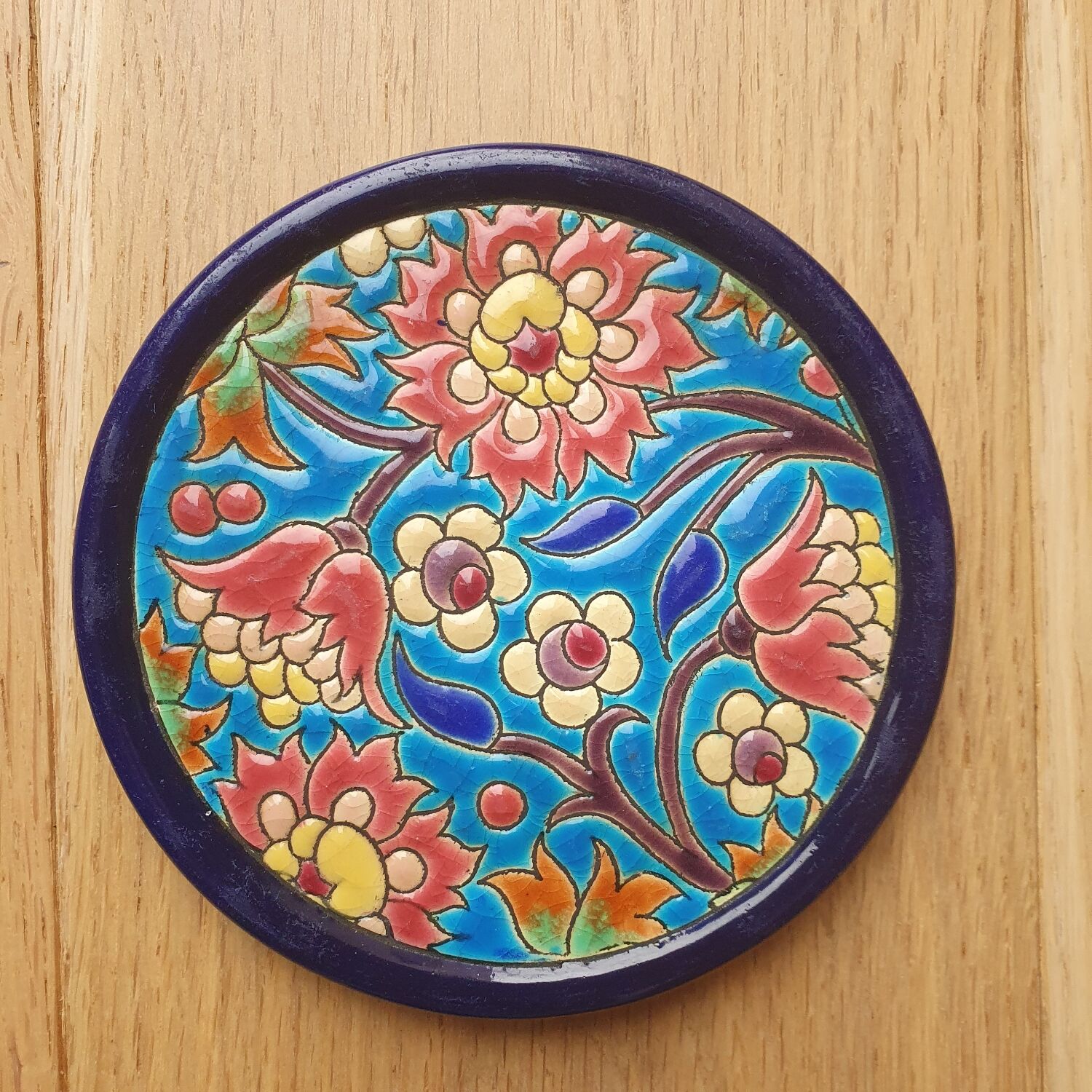 Trivet and Longwy enamel bottle