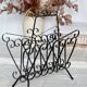 Vintage black metal scroll magazine rack